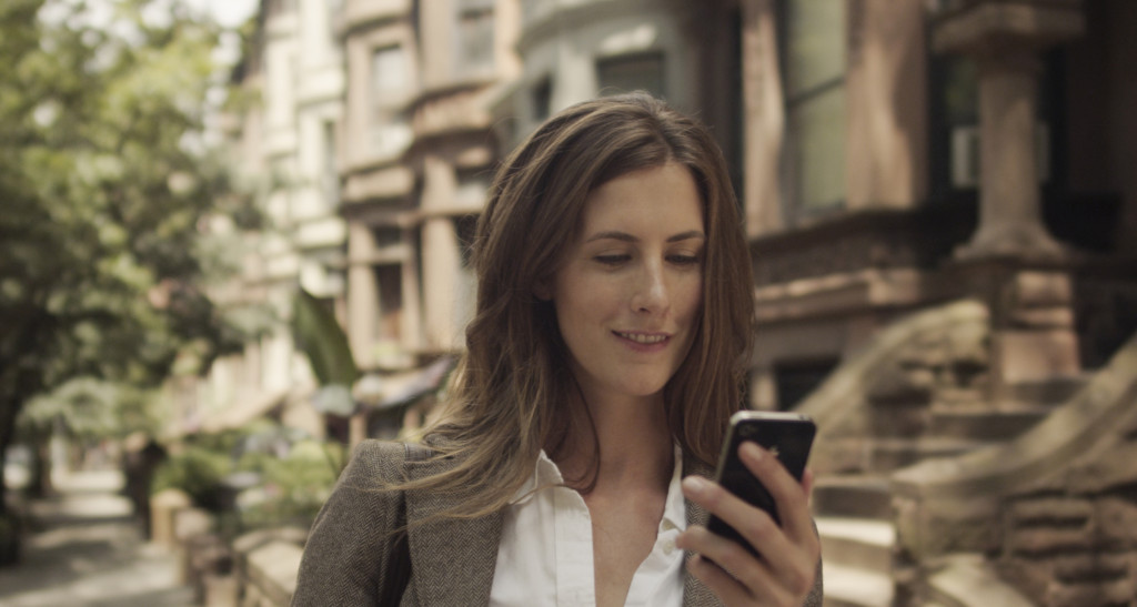 woman checking her canary app while out